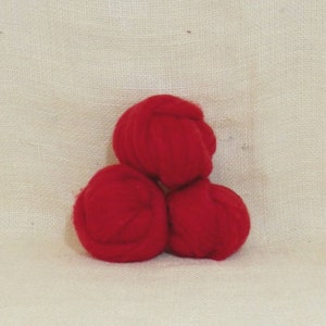 May include: Three balls of red wool yarn.