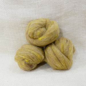 May include: Three balls of wool yarn in shades of brown and yellow. The yarn is soft and fluffy, and it would be perfect for knitting or crocheting.