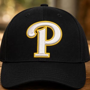 May include: A black baseball cap featuring a large, embroidered letter P on the front. The letter P is white with a thick yellow border, stitched in a bold, serif font. The cap has a structured crown, a curved brim, and matching black eyelets.