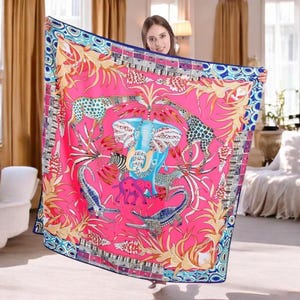 May include: A vibrant pink square scarf featuring a detailed animal and plant design. The scarf showcases an elephant, giraffes, zebras, and crocodiles, surrounded by intricate floral and geometric patterns. The border is a mix of blue, white, and gold.