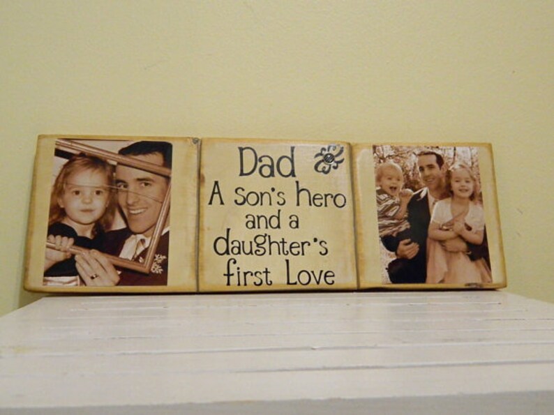 May include: A three-piece wooden sign with a photo of a father and his children. The middle piece reads "Dad A Son's hero and a daughter's first love".