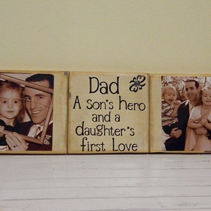 May include: A wooden sign with three panels. The center panel has the text "Dad A son's hero and a daughter's first love". The left panel has a photo of a father and daughter. The right panel has a photo of a father with two children.