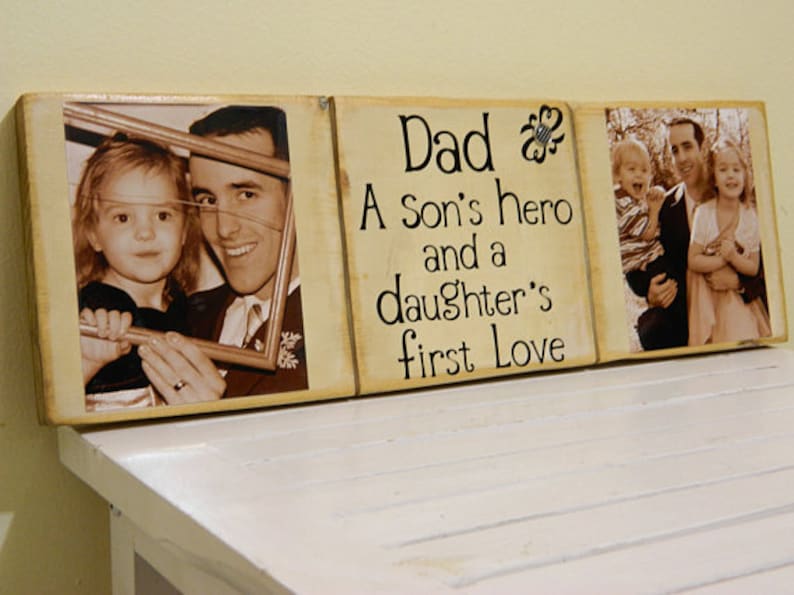 May include: A wooden sign with three panels. The center panel has the text "Dad A Son's hero and a daughter's first Love". The left panel has a photo of a father and daughter. The right panel has a photo of a father and two children.