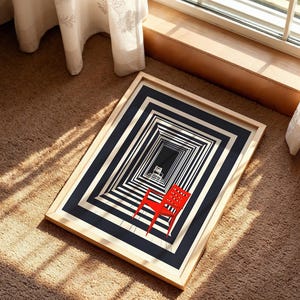 May include: A framed print featuring a black and white graphic illustration of a repeating rectangular tunnel pattern. A single bright red chair is positioned in the foreground, while a smaller white chair is visible in the distance.