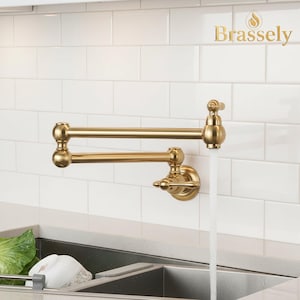 Grifo de cocina plegable con brazo oscilante y montaje en pared en oro cepillado