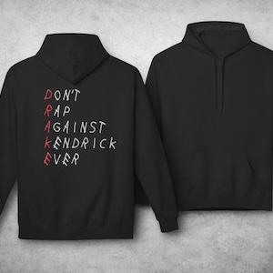 May include: Black hoodie with the text "DON'T RAP AGAINST KENDRICK EVER" in red and white. The hoodie has a hood, long sleeves, and a front pocket. The image shows the front and back of the hoodie.