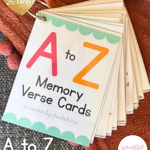 May include: A to Z Memory Verse Cards, includes 26 cards. The cards are held together by a metal ring. The cover features the text "A to Z Memory Verse Cards" with the letters A and Z in bright colors. The cards are designed by Scripted by Soulshine.