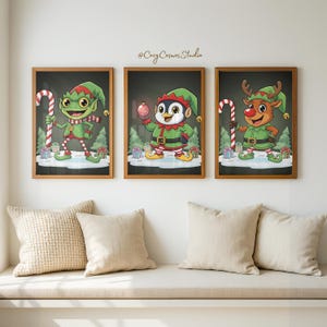 May include: Three framed Christmas art prints. Each print features a cartoon character: an elf, a penguin, and a reindeer, all in festive outfits. They hold Christmas items like a candy cane or bauble, set against a dark backdrop with snow and trees.