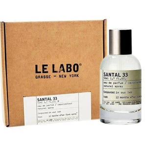 May include: A clear glass bottle of Santal 33 eau de parfum with a silver cap, beside a brown cardboard box. The bottle label reads "SANTAL 33 50ml 1.7 FL.OZ." and "eau de parfum / natural spray."