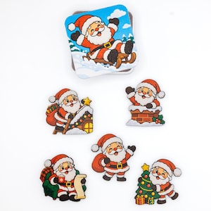 May include: A set of six wooden Santa Claus ornaments featuring various festive scenes including Santa on a sled, climbing a roof, in a chimney, sitting in a chair, standing with a sack, and decorating a Christmas tree with colorful lights.