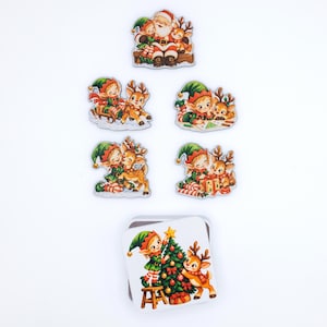 May include: A collection of five die-cut stickers and one square coaster featuring vintage-style illustrations of Santa Claus, elves, and reindeer. The designs include scenes of gift-giving, decorating a Christmas tree, and playing in the snow with red, green, and brown color palettes.