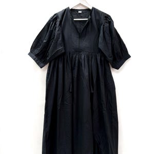 Vestido midi de algodón negro: forro completo, ribete de encaje, cierre de cordón y escote profundo.