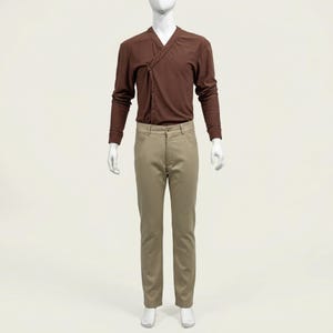 May include: A brown long-sleeve shirt with a knotted front detail and khaki-colored pants. The outfit is displayed on a mannequin against a plain background. The pants have a classic five-pocket design.