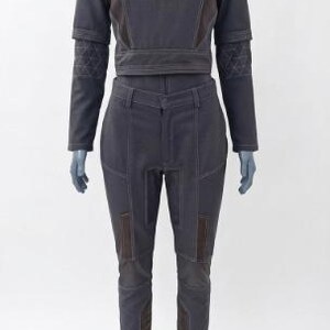 May include: A two-piece outfit in dark gray, featuring a cropped jacket with a high collar and long sleeves, paired with matching pants. The jacket has decorative stitching and brown accents. The pants have brown patches on the knees.