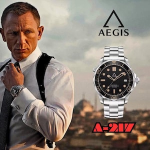 May include: A silver-tone stainless steel wristwatch with a black dial, luminous markers, and a rotating bezel. The watch face features the Aegis logo and the text A-217. The design includes a metal link bracelet and a date display window.