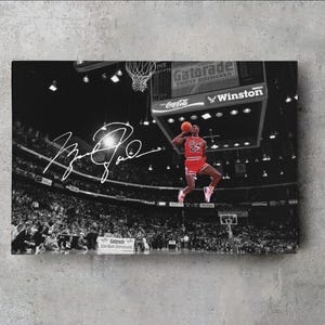May include: Monochrome print featuring a basketball player in a red jersey, number 23, mid-jump. The image includes a signature, and the Gatorade and Winston logos are visible.
