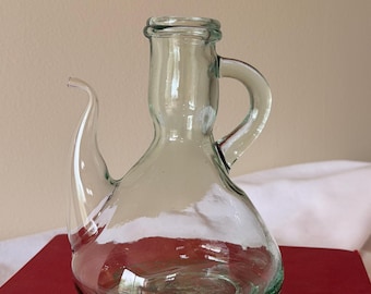 Vintage small pale green glass cruet with handle and curved spout