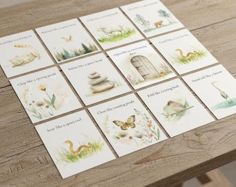 May include: A collection of twelve small cards with watercolor illustrations and text. Each card features a different image, including a cat, a bird, a snake, and a butterfly, with phrases like "Stretch like a waking cat" and "Soar like a quiet owl."