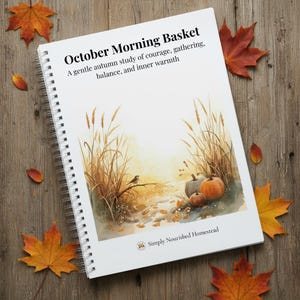 May include: A spiral-bound notebook titled "October Morning Basket" with an autumn-themed watercolor illustration. The cover features pumpkins, tall grass, and the text "A gentle autumn study of courage, gathering, balance, and inner warmth."
