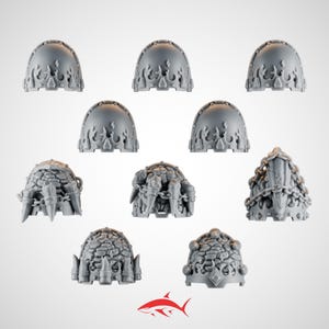 May include: A collection of gray, miniature, fantasy-themed armor pieces. The set includes domed shoulder pads with flame-like designs and detailed, textured helmet-like structures. A red shark logo is at the bottom.