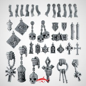 May include: A selection of grey miniature gothic accessories, including skulls, crosses, shields, books, and keys. The pieces are designed with intricate details, likely for a miniature game or model.