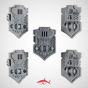 May include: Five gray plastic shields with intricate details. Each shield has a unique design, including decorative elements, vents, and mechanical components. The shields are likely for a miniature wargame or model kit.