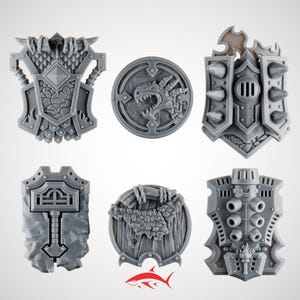 May include: Six gray miniature shields with various designs, including a dragon, a hammer, and a spiked shield. The shields are likely for tabletop gaming or miniature wargaming. The shields are made of plastic.