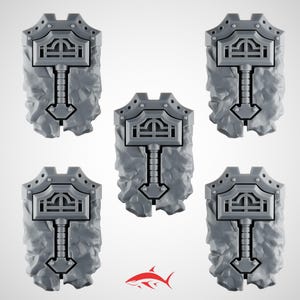 May include: Five gray, shield-shaped objects with a hammer design. The shields have a textured, rocky appearance and a detailed hammer emblem at the top. The hammer's handle extends down the shield's center. The objects are arranged against a white background.