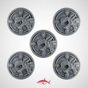 May include: Five gray, circular game bases with a detailed dragon head design. Each base features a raised dragon head in the center, surrounded by a decorative border. The bases are made of a durable material and are suitable for tabletop gaming.