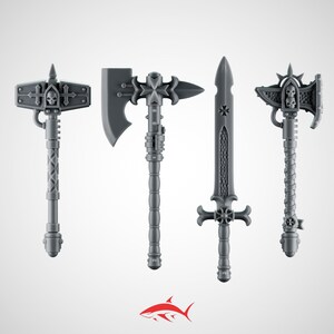 May include: A set of four grey miniature weapons including a hammer with a skull emblem, a battle axe with a cross motif, a straight sword with a textured blade, and a smaller axe featuring a double skull design, all with detailed handles.