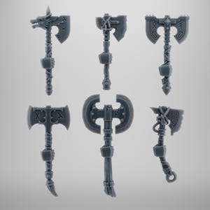 May include: Six gray miniature axes with detailed designs, including runes and wolf heads. The axes have various blade shapes and handle styles, suitable for tabletop gaming or crafting projects.