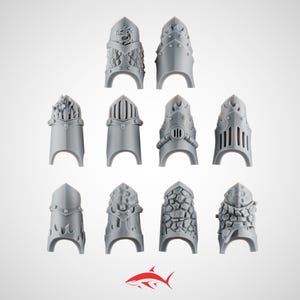 May include: A collection of ten gray miniature armor pieces, each with a unique design. The pieces feature various textures and shapes, including dragon scales, rivets, and stone-like patterns. The pieces are arranged against a white background.