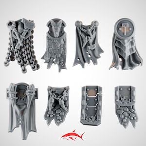 May include: Eight gray miniature fantasy armor pieces. The designs include capes, shields, and chainmail, with details like hammers, dragon heads, and textured stone patterns. A red shark logo is at the bottom.