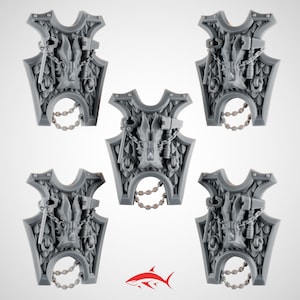 May include: Five gray, shield-shaped miniatures with intricate dragon and chain details. Each shield features a central dragon head, a key, and a hammer, connected by chains. The shields have a decorative, scale-like pattern and a chain at the bottom.