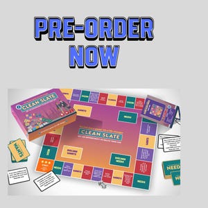 May include: A board game titled "CLEAN SLATE" with the text "PRE-ORDER NOW" at the top. The game includes a game board, cards labeled "WANTS" and "NEEDS", dice, and a box. The game board has a colorful design with various spaces.