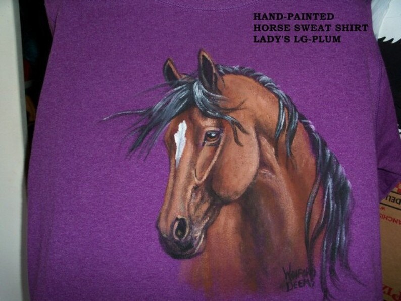 May include: Purple hand-painted horse sweat shirt with the text "HAND-PAINTED HORSE SWEAT SHIRT LADY'S LG-PLUM" and the artist's signature "WorFo DEEMS".