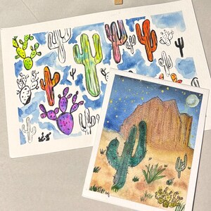 May include: Watercolor paintings of cacti. One painting features colorful cacti against a blue sky background. The other painting depicts a desert landscape with a large cactus, mountain, and starry night sky.