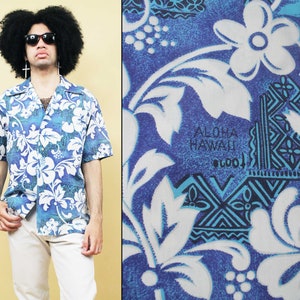 May include: A blue and white Hawaiian shirt with a floral pattern and the text "Aloha Hawaii" printed on the front.