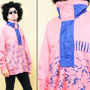 May include: A pink and blue windbreaker jacket with a geometric pattern. The jacket has a high collar and a zipper closure.