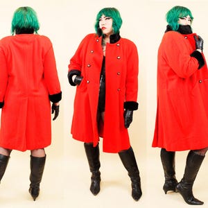 May include: A vibrant red vintage coat with black trim on the collar and cuffs. The coat features a double-breasted design with black buttons and a classic silhouette. The coat is paired with black gloves and knee-high boots.