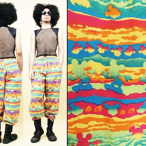 May include: A pair of colorful pants with a Mickey Mouse print. The pants are made of a lightweight fabric and have a relaxed fit. The pants are a great choice for a casual look.