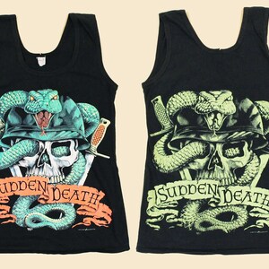 May include: Two black tank tops with a skull and snake graphic. The graphic features a skull with a snake wrapped around it, a military helmet, and two daggers. The text "Sudden Death" is printed on a banner below the skull.