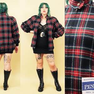 May include: A black and red plaid jacket with a zipper closure. The jacket has a label that reads "Warranted to be a Pendleton 100% Virgin Wool".
