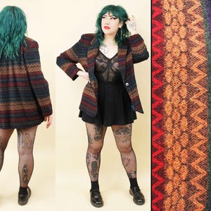 May include: A vintage blazer with a colorful geometric pattern in shades of brown, red, green, and blue. The blazer has a classic tailored fit with a single-button closure. The fabric has a textured appearance, and the design is repeated throughout the garment.