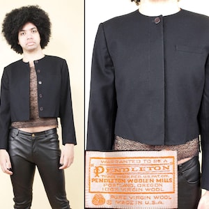 May include: A black Pendleton wool jacket with a round collar and a single button closure. The jacket has a small pocket on the left side. The label reads "Pendleton Woolen Mills, Portland, Oregon, 100% Virgin Wool, Made in U.S.A."