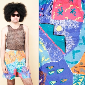 May include: A brown mesh tank top and colorful patterned shorts. The shorts feature a vibrant mix of blue, orange, pink, and turquoise with abstract shapes and designs. The overall style is retro and bold.