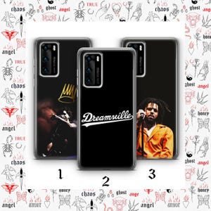 May include: Three black phone cases with different designs. One features a gold crown, another has the word "Dreamville" in white script, and the third displays a person holding a microphone. The cases have a clear border and a camera cutout.
