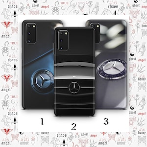 May include: Three phone cases featuring Mercedes-Benz designs. Case 1 has a dark blue and silver emblem. Case 2 shows a black and gray car front. Case 3 displays a silver emblem on a gray background. The background has tattoo-style illustrations.