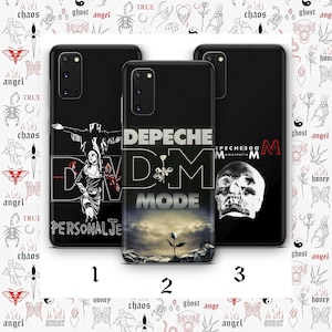 May include: Three black phone cases with Depeche Mode designs. One case features a figure with outstretched arms, another displays the band's logo with a landscape, and the third showcases a skull. The cases are numbered 1, 2, and 3.