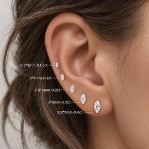 May include: Five marquise-cut clear stud earrings arranged in a row, labelled with sizes: 1.5*3mm-0.05ct, 2*4mm-0.1ct, 2.5*5mm-0.2ct, 3*6mm-0.3ct, and 3.5*7mm-0.4ct. Each earring features a single faceted stone set in a metallic base.